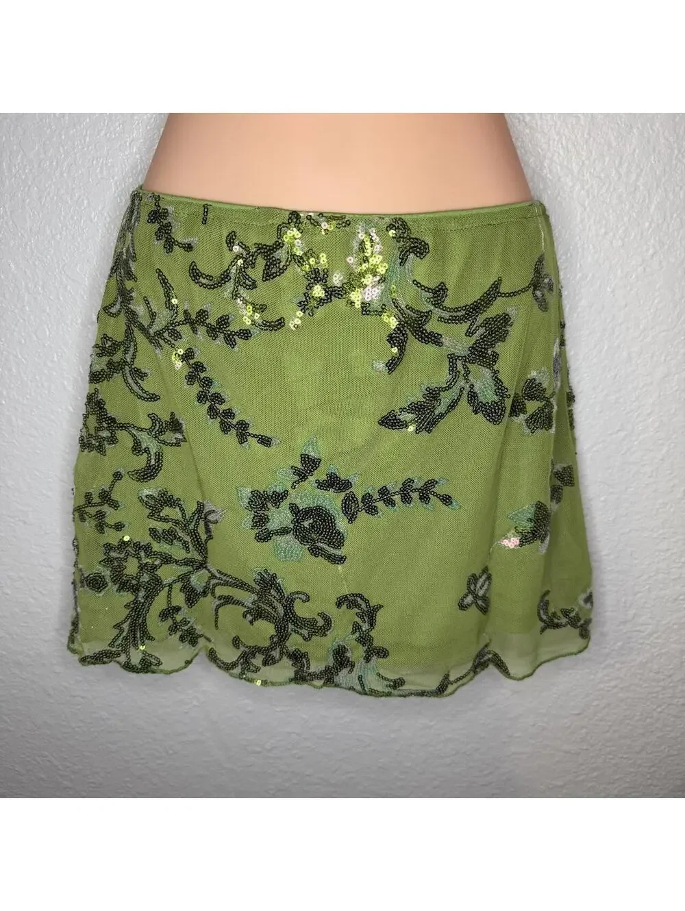 Green beaded mini skirt with black floral embroidery and sequins